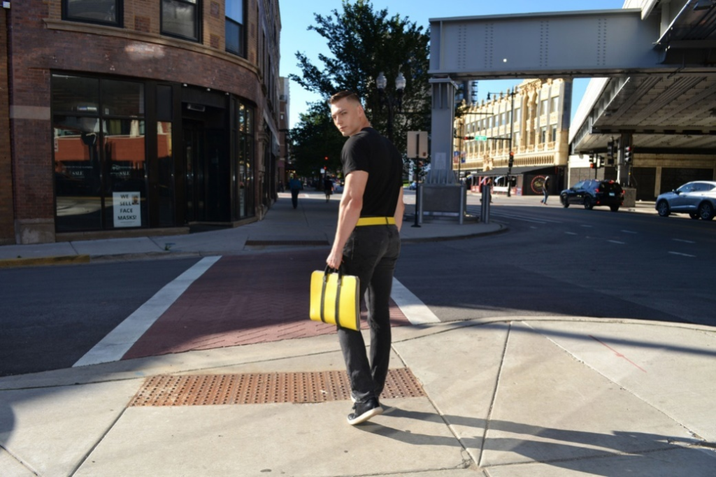 A person carrying a fire hose business case