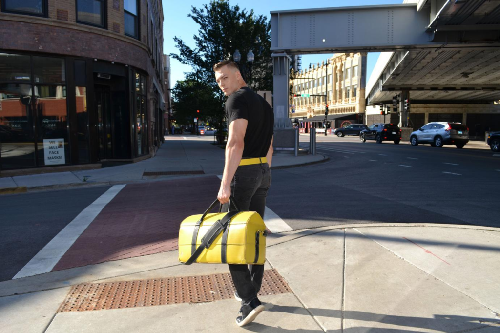 A man carrying an upcycled duffel bag