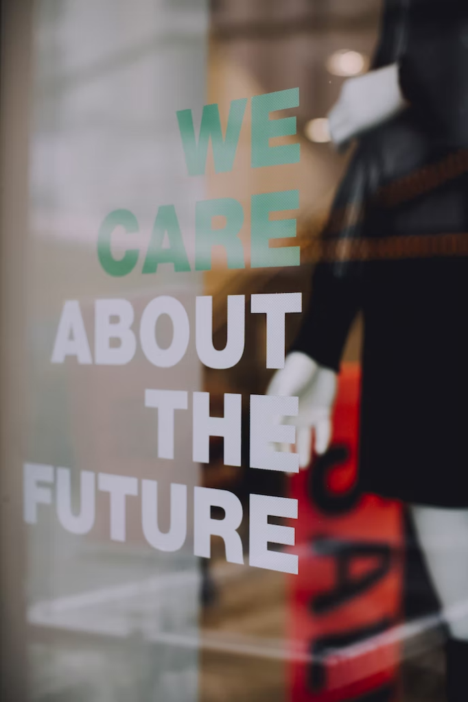 An image of a glass window at a brand outlet with the statement we care about the future